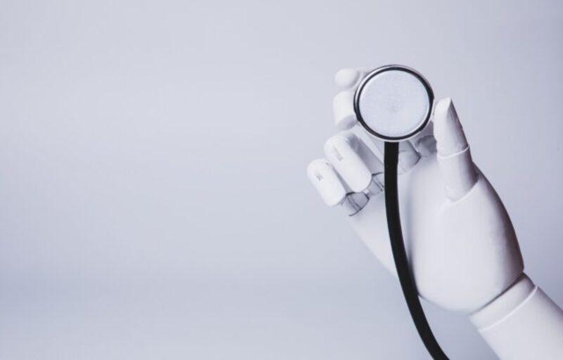 A robot hand holding a stethoscope.